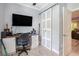 Home office with a desk, sliding closet door, providing a functional and organized workspace at 5174 Ridge Tarn, Acworth, GA 30102