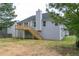 Backyard view shows a wooden deck and stairs with a large lawn surrounded by trees at 5452 Sweetsprings, Powder Springs, GA 30127