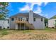 Backyard view features a wooden deck and stairs leading to a spacious lawn at 5452 Sweetsprings, Powder Springs, GA 30127