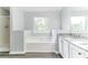 Bright bathroom showcasing a soaking tub, granite countertops, and a separate shower at 5452 Sweetsprings, Powder Springs, GA 30127