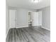 Well-lit primary bedroom with wood floors leading to a view of the attached bathroom at 5452 Sweetsprings, Powder Springs, GA 30127