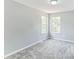 Sunlit bedroom with neutral walls and carpet and two windows at 5452 Sweetsprings, Powder Springs, GA 30127