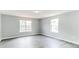 Spacious bedroom featuring gray flooring, two large windows providing natural light, and neutral wall colors at 5452 Sweetsprings, Powder Springs, GA 30127