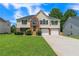 Two-story home with a brick-accented facade, well-manicured lawn and a two-car garage at 5452 Sweetsprings, Powder Springs, GA 30127