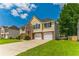Two-story house with a well-kept lawn, brick details and a two-car garage at 5452 Sweetsprings, Powder Springs, GA 30127