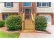 Close-up of a wooden front door with glass sidelights and freshly stained porch steps at 5452 Sweetsprings, Powder Springs, GA 30127