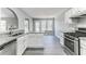 Bright kitchen with stainless steel appliances, white cabinets, and an island with bar seating at 5452 Sweetsprings, Powder Springs, GA 30127