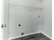 Bright laundry room featuring gray walls, modern flooring, and a wire shelf for storage at 5452 Sweetsprings, Powder Springs, GA 30127