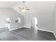 Open concept living room with gray walls, ceiling fan and dark wood-look floors at 5452 Sweetsprings, Powder Springs, GA 30127