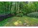 Spacious backyard surrounded by mature trees and shrubbery, offering privacy and tranquility at 732 S Fairfield Dr, Peachtree City, GA 30269