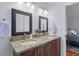 Bathroom featuring double vanity with granite countertop, matching framed mirrors, and updated fixtures at 732 S Fairfield Dr, Peachtree City, GA 30269