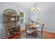 Bright dining area with natural light, featuring a round table, four chairs, and a decorative wicker shelf at 732 S Fairfield Dr, Peachtree City, GA 30269