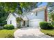 Charming home with blue siding, red brick accents, a well-manicured front yard and a garage at 732 S Fairfield Dr, Peachtree City, GA 30269