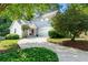 Charming two-story home featuring a well-manicured lawn and a curved driveway leading to an attached two-car garage at 732 S Fairfield Dr, Peachtree City, GA 30269