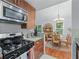 Well-equipped kitchen featuring granite countertops, stainless steel appliances, and dark wood cabinetry at 732 S Fairfield Dr, Peachtree City, GA 30269
