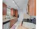 Well-equipped kitchen featuring granite countertops, stainless steel appliances, and dark wood cabinetry at 732 S Fairfield Dr, Peachtree City, GA 30269