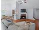 Inviting living room featuring vaulted ceiling, hardwood floors, fireplace, and a comfortable sectional sofa at 732 S Fairfield Dr, Peachtree City, GA 30269