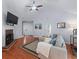 Inviting living room featuring vaulted ceiling, hardwood floors, fireplace, and a comfortable sectional sofa at 732 S Fairfield Dr, Peachtree City, GA 30269
