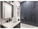 Modern bathroom with marble sink and black hardware, and black and white herringbone tiling at 320 Martin Luther King Jr Se Dr # 15, Atlanta, GA 30312