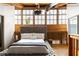 Bright bedroom with large windows, wooden beams, and bed with tufted headboard at 320 Martin Luther King Jr Se Dr # 15, Atlanta, GA 30312