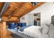Cozy loft bedroom with exposed wood beams, ensuite bathroom, blue sofas, and large white-covered bed at 320 Martin Luther King Jr Se Dr # 15, Atlanta, GA 30312