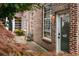 Brick exterior with chair and door labeled 15 with well-manicured foliage at 320 Martin Luther King Jr Se Dr # 15, Atlanta, GA 30312