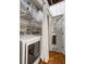 Bright laundry area with washer and dryer, open shelving, separated by a modern white curtain, leads to a bathroom at 320 Martin Luther King Jr Se Dr # 15, Atlanta, GA 30312