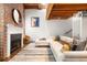 Living room with fireplace, exposed brick, wood floors, modern furniture, and art at 320 Martin Luther King Jr Se Dr # 15, Atlanta, GA 30312