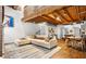 Open-concept living space with wood floors, exposed ceiling beams, modern furniture, and art at 320 Martin Luther King Jr Se Dr # 15, Atlanta, GA 30312