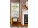 Living room showcasing brick walls, large windows, fireplace, and hardwood floors at 320 Martin Luther King Jr Se Dr # 15, Atlanta, GA 30312