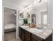 Bathroom featuring double sinks, granite countertops, and large mirror at 3406 Pennington Dr, Lithonia, GA 30038