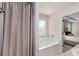 Relaxing soaking tub in updated bathroom, near bedroom entrance at 3406 Pennington Dr, Lithonia, GA 30038