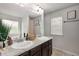 Bright bathroom featuring double sinks, granite countertops, and large mirror at 3406 Pennington Dr, Lithonia, GA 30038