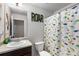 bathroom with dinosaur-themed shower curtain and themed decor at 3406 Pennington Dr, Lithonia, GA 30038