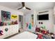 bedroom featuring ceiling fan, dresser, and playful decor at 3406 Pennington Dr, Lithonia, GA 30038