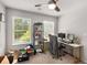 Bedroom setup with dual monitors, desk, shelving and bright window at 3406 Pennington Dr, Lithonia, GA 30038