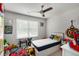 bedroom with ceiling fan, window with blinds, and colorful decorations at 3406 Pennington Dr, Lithonia, GA 30038