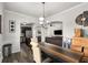 Dining room view with an arched doorway looking into the modern kitchen and spacious living area at 3406 Pennington Dr, Lithonia, GA 30038