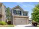 Charming two-story home with a two-car garage and a combination of brick and siding exterior at 3406 Pennington Dr, Lithonia, GA 30038