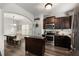 Modern kitchen with dark cabinets, stainless steel appliances, and an island at 3406 Pennington Dr, Lithonia, GA 30038