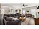 Open-concept living room with a large sectional sofa, hardwood floors, and an arched entryway at 3406 Pennington Dr, Lithonia, GA 30038