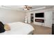Comfortable main bedroom with walk-in closet, mounted tv, and electric fireplace at 3406 Pennington Dr, Lithonia, GA 30038