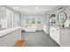 Modern bathroom with a freestanding tub, double vanity, grey floors, and shiplap walls at 410 Dalrymple Ne Rd, Atlanta, GA 30328