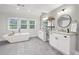 A bright and airy bathroom featuring a soaking tub, dual vanities, and stylish fixtures at 410 Dalrymple Ne Rd, Atlanta, GA 30328