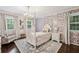 Charming bedroom featuring floral wallpaper, a four-poster bed, and plenty of natural light at 410 Dalrymple Ne Rd, Atlanta, GA 30328