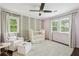 Cozy Bedroom featuring leafy wallpaper, a comfortable chair, and a modern ceiling fan at 410 Dalrymple Ne Rd, Atlanta, GA 30328