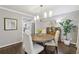 Dining room with a round table, modern lighting, hardwood floors, and neutral paint colors at 410 Dalrymple Ne Rd, Atlanta, GA 30328