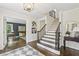 Welcoming foyer with hardwood floors, staircase, and stylish decor leading to rooms with French Doors at 410 Dalrymple Ne Rd, Atlanta, GA 30328