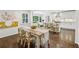 Open kitchen boasts bright white cabinetry and stainless steel appliances adjacent to a farmhouse-style dining area at 410 Dalrymple Ne Rd, Atlanta, GA 30328