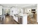 Open-concept kitchen with stainless steel appliances and marble counter tops overlooks the dining and living areas at 410 Dalrymple Ne Rd, Atlanta, GA 30328